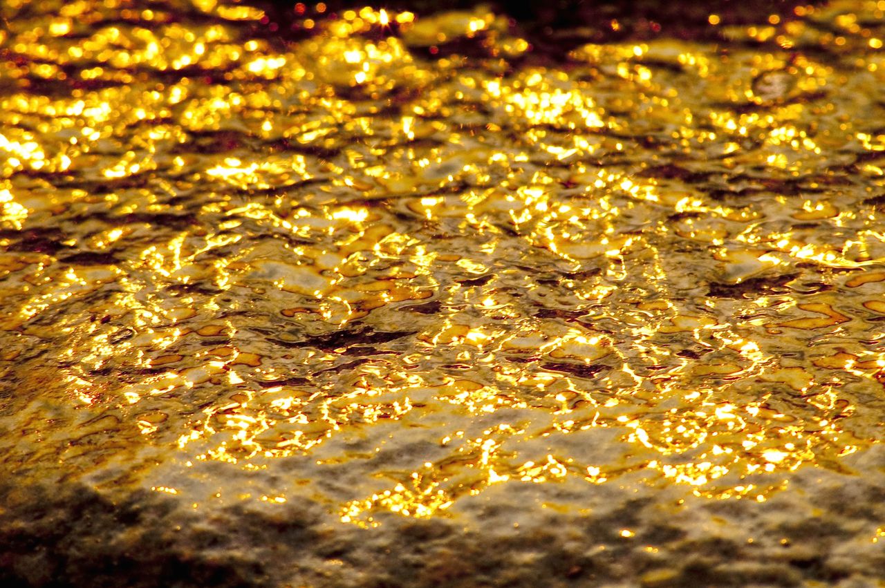 A mesmerizing display of golden light reflected on water at Steep Rock, Manitoba, Canada.